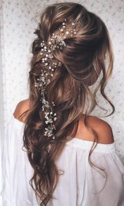 Long wedding day hairstyle flower headpiece loose braid