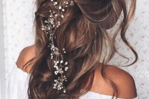 Long wedding day hairstyle flower headpiece loose braid