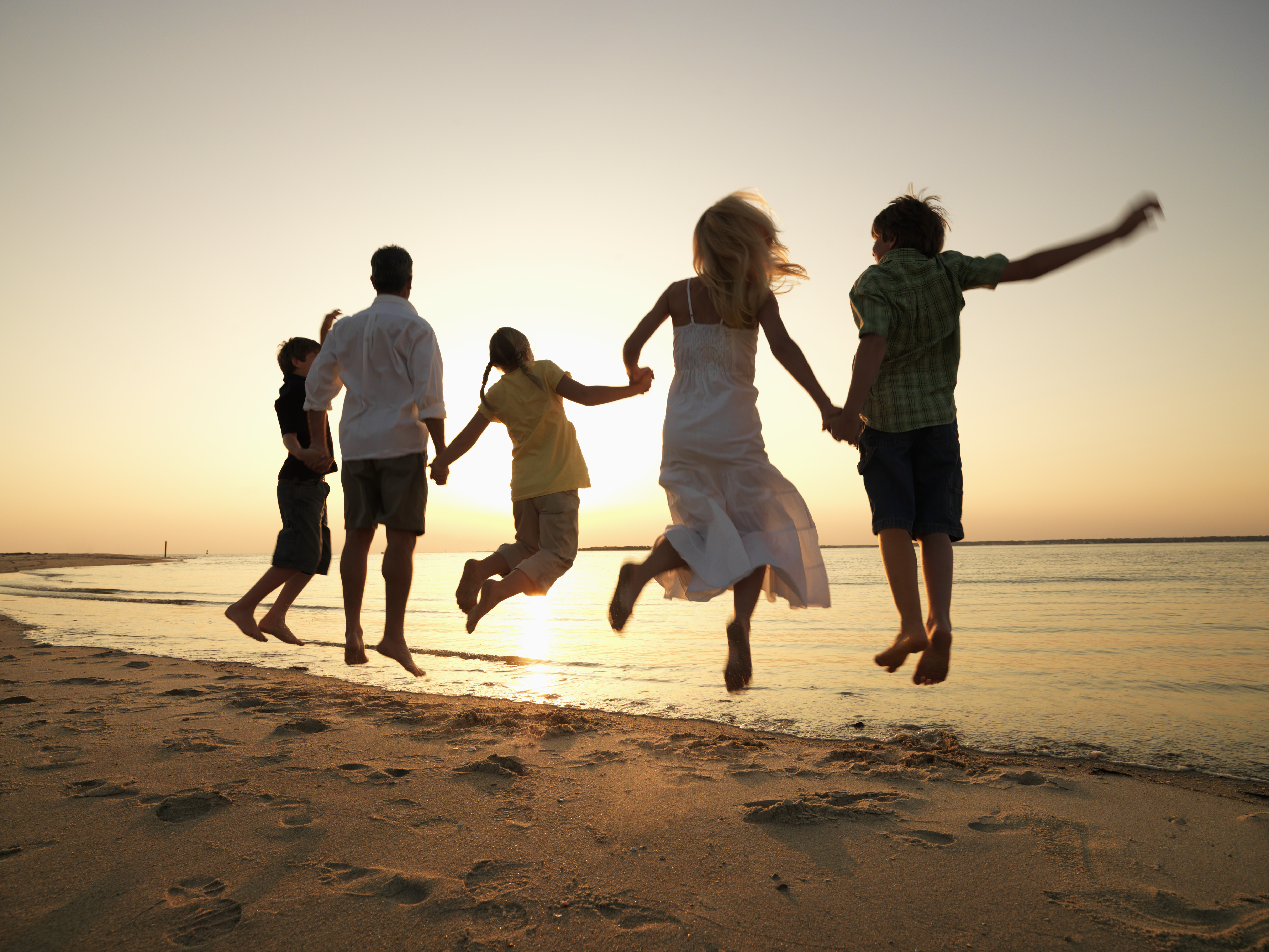 Family Jumping on Beach