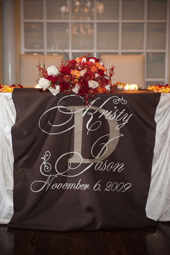 Custom aisle runner looks great on head table at the reception