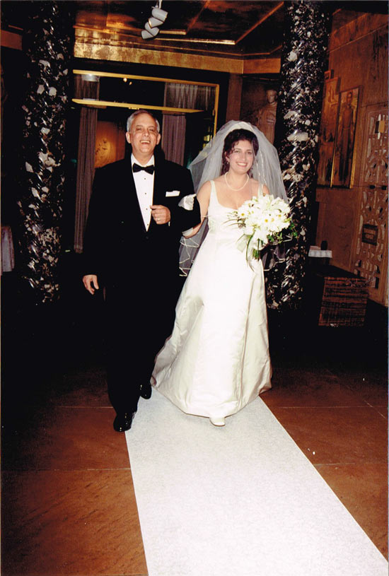 Walking down the aisle at wedding at National Shrine of the Little Flower